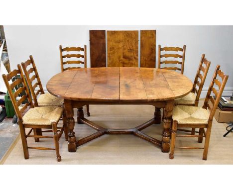 A good quality reproduction burr oak extendable dining table with three additional leaves on block legs, height 76cm, length 