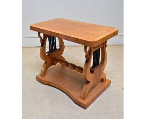 A contemporary satinwood console table with carved swan and lyre form supports, width 80cm.
