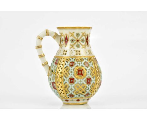 ROYAL WORCESTER; a reticulated baluster form vase with single bamboo effect handle, with turquoise, maroon and gilt painted a