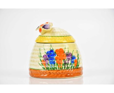 CLARICE CLIFF; a Bizarre range Beehive honeypot and cover in the 'Crocus' pattern, height 7cm.Condition Report: Restoration t