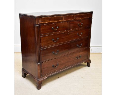 An early 19th century inlaid mahogany chest, with two frieze drawers, two small drawers and three long drawers, on ogee brack