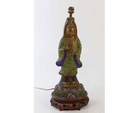 A Chinese cloisonné table lamp modelled as Guanyin, in carved wooden plinth base, height 52cm.Condition Report: Grubby throug