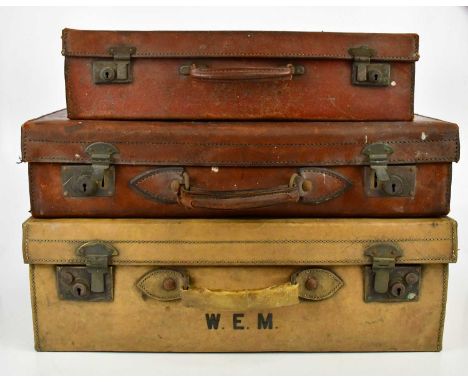 Three vintage leather suitcases, one bearing initials 'W.E.M', largest height 20cm, width 60cm, depth 40cm.