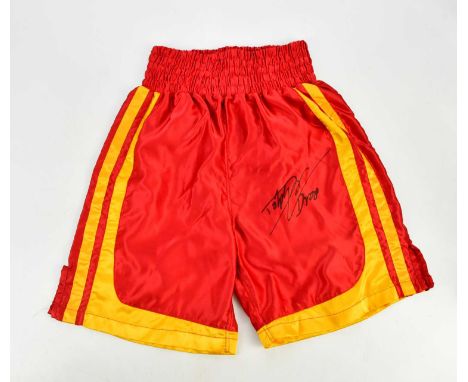 DOLPH LUNDGREN; a pair of red and yellow boxing shorts, signed to front, size M.Condition Report: Light creasing throughout, 