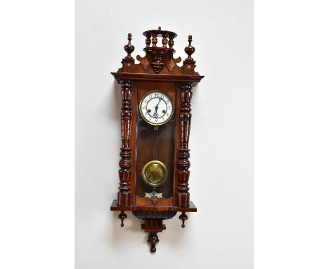 A mahogany cased Vienna style wall clock with white enamel dial set with Arabic numerals, approx 84cm.