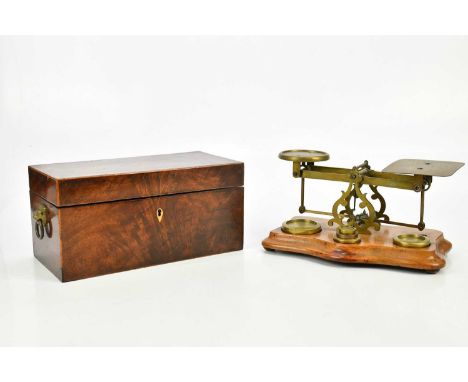 A 19th century inlaid mahogany tea caddy of rectangular form, length 30cm, and a set of postal scales with assorted weights.