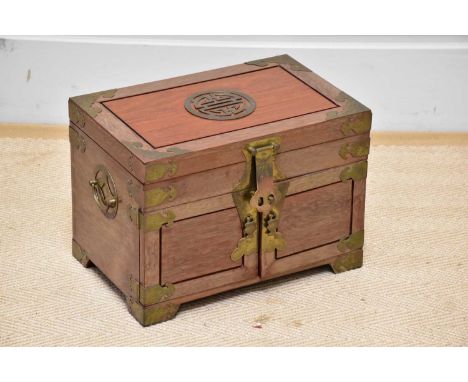 A Chinese hardwood and brass mounted trinket box, height 25cm, width 35cm, depth 23cm.