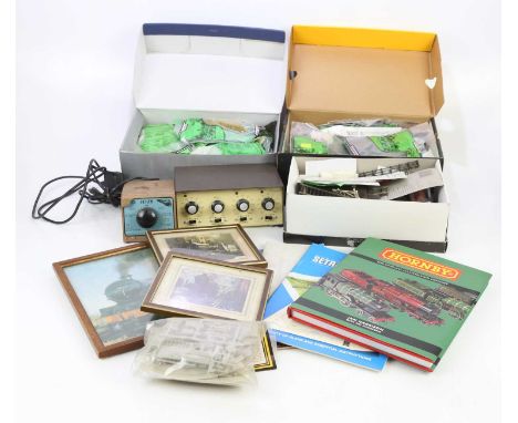An assorted collection of model train set items to include miniature trees, gravel, track, power supplies, etc.