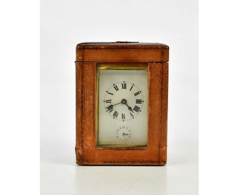 A brass cased carriage clock with white enamel dial set with Roman numerals and subsidiary dial, height 11cm, in travelling c