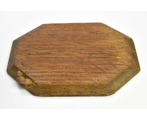 WORKSHOP OF ROBERT MOUSEMAN THOMPSON; an oak breadboard of shaped octagonal form, length 30cm.