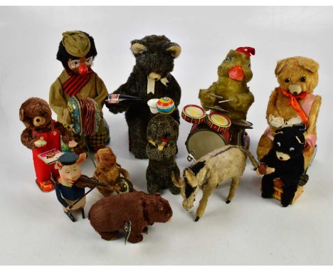 A collection of wind-up toys including a Japanese tinplate duck playing drums, a bear drinking Pepsi Cola, clown playing acco