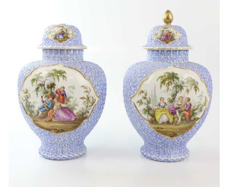 AUGUSTUS REX; a pair of German porcelain floral encrusted vases and covers, painted with scenes of figures in gardens, blue p