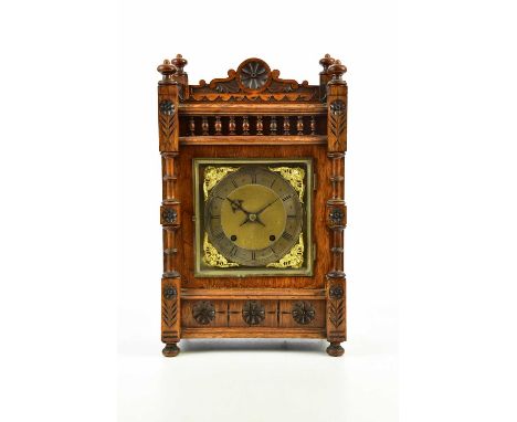 WINTERHALDER &amp; HOFMEIER; a late 19th century walnut cased mantel clock, with raised back and four finials above the silve