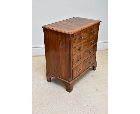 An early 20th century walnut and crossbanded chest with brushing slide above four long drawers, on bracket feet, width 76cm.