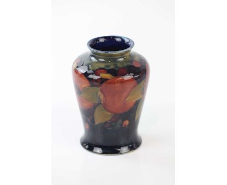 WALTER MOORCROFT; a vase of shouldered form decorated in the 'Pomegranate' pattern, with one open pomegranate, height 13.5cm.