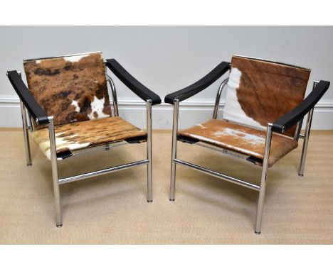 LE CORBUSIER; a pair of chrome framed LC 1 easy chairs upholstered in a brown and white hide (2).Provenance: Complete with or