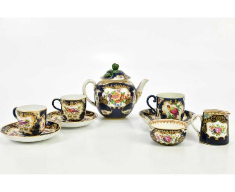 WORCESTER; a late 18th century teacup and saucer, painted with exotic birds and insects in a cobalt blue border, and a simila