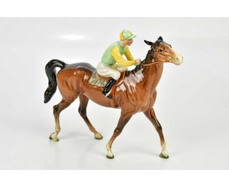 BESWICK; a model of a horse and jockey, height 20cm.Condition Report: Right ear had been broken off but the piece is present.
