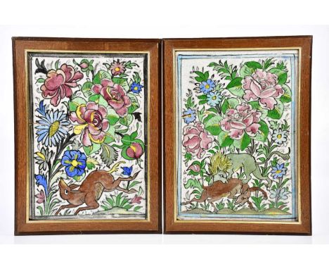 A pair of Iznik ceramic tiles decorated with a hunting scene and deer in landscape, 32 x 22cm, each framed (one af)