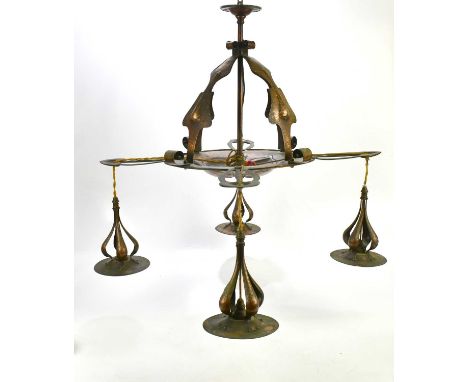 An Arts & Crafts planished copper hanging ceiling light, with four arms supporting a circular dish with embossed floral detai