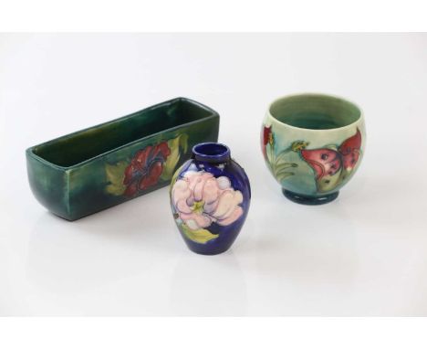MOORCROFT; three pieces including a planter in the 'Arum Lily' pattern, height 8cm, a planter in the 'Hibiscus' pattern, leng