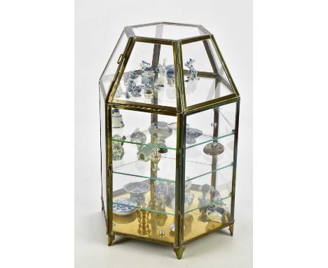 A collection of decorative miniatures, predominantly blue and white ceramic, contained in a hexagonal cabinet, height 40cm.