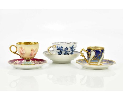 VIENNA; a hand painted teacup and saucer, painted with five cherubs, signed 'A Heur', a Limoges teacup and saucer with jewell