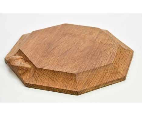 WORKSHOP OF ROBERT MOUSEMAN THOMPSON; an oak cheeseboard of octagonal form, diameter 19cm.