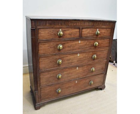 An early 19th century mahogany chest, with brass knob handles, with two short and four graduated long drawers, on ogee bracke