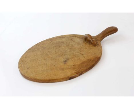 WORKSHOP OF ROBERT MOUSEMAN THOMPSON; an early oak cheeseboard with carved mouse to board, length 35cm.Condition Report: Mini