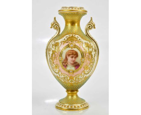 COALPORT; a fine twin handled pedestal urn vase with turquoise jewelling and elaborate gilt scrolling and floral decoration s
