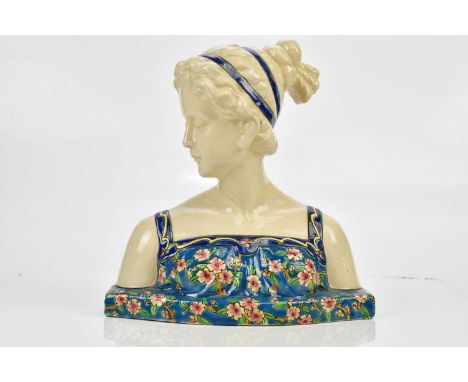 An Art Deco ceramic female bust in the manner of Longwy, decorated with flowers, printed marks, height 25cm.Condition Report: