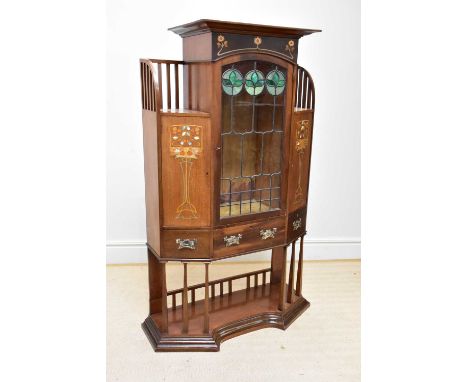 An early 20th century Art Nouveau inlaid mahogany display cabinet, with central stained leaded glass door flanked by doors ab
