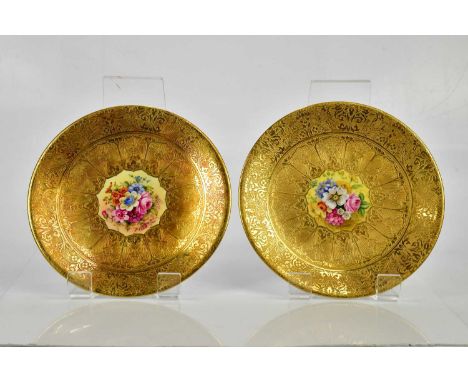Two Royal Worcester cabinet plates, each painted to the centre with floral sprays, signed by T. Freeman and F. Higgins inside