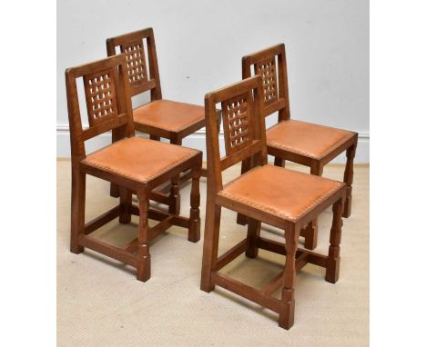 WORKSHOP OF ROBERT MOUSEMAN THOMPSON; a set of four oak lattice back dining chairs with leather seats (4).