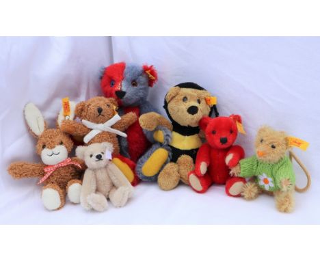 A modern Steiff two tone teddy bear, together with four other Steiff teddy bears, a Steiff rabbit and a Steiff bear dressed a