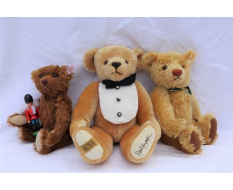 A Steiff 2001 teddy bear, produced for the Danbury mint, together with another Steiff teddy bear holding a toy soldier and a 