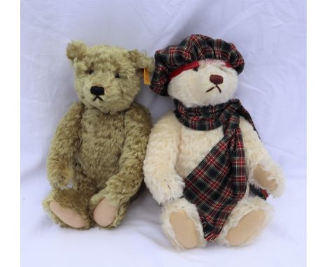 A modern Steiff teddy bear, with a cream mohair articulated body in a tartan hat and scarf, together with a golden mohair Ste