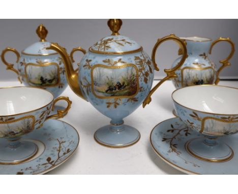 A continental porcelain cabaret set, painted with vignettes of birds by a river with raised gilt decoration to a pale blue gr