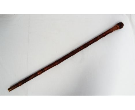 A Japanese bamboo walking stick, with a root knop handle, the body carved with a figure, eagle, leaves and crosshatching, 91c