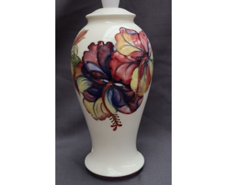 A Moorcroft pottery table lamp, decorated in the Hibiscus pattern to a cream ground, impressed mark, 28cm high