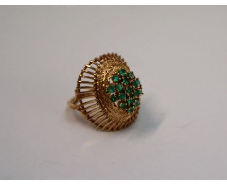 A 14ct yellow gold dress ring, set with a cluster of light green stones, possibly peridot, to a raised claw setting, basket w