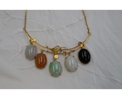 A Chinese yellow metal necklace set with jade and hard stone panels, decorated with leaves and wirework, marked 585, 52cm lon