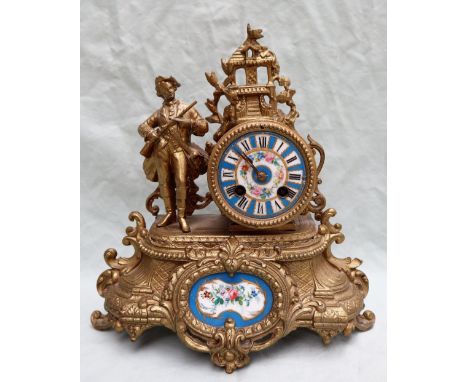 A 19th century French gilt spelter mantle clock, the drum shaped clock with castle surmount with a figure of an officer offse