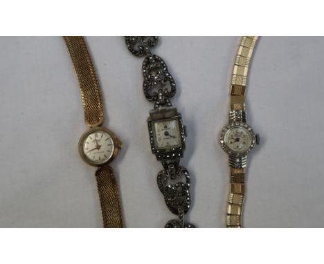 A Lady's 9ct yellow gold and diamond encrusted cocktail watch, the circular dial with Arabic numerals and batons inscribed El