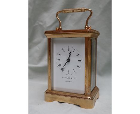 A 20th century English brass cased carriage clock, the enamel dial with Roman numerals inscribed "Garrard &amp; Co London W1"