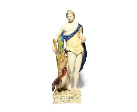 A large Lakin & Poole (Staffordshire) figure of Ganymede, c.1800-10, the young hero standing beside a tall trunk with an eagl
