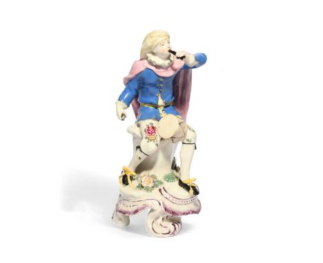 A Bow figure of a musician, c.1765, seated with a small drum between his knees and playing the flageolet, wearing a baggy clo