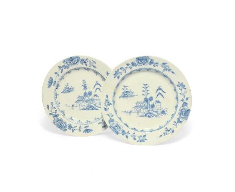 A pair of early Bow blue and white plates, c.1755, painted to the wells with two Chinese figures before buildings and trees, 