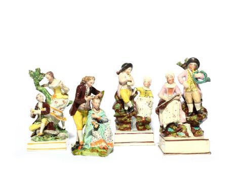 A pair of Staffordshire figure groups of musicians, c.1810, on rocky outcrops, one playing the flageolet while his companion 